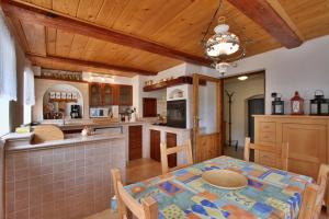 a kitchen with a table and a dining room at Chalupa Lenička in Chřibská