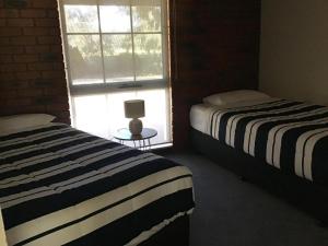 Voodi või voodid majutusasutuse Fairway Views Motor Inn toas
