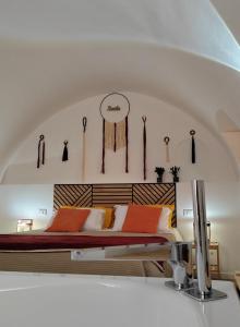 a bedroom with a bed with a wooden headboard at La Chianca Jacuzzi & Stone - Cozy Apartment - Conversano in Conversano