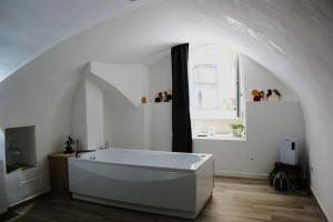 a white bathroom with a large tub in a room at La Chianca Jacuzzi & Stone - Cozy Apartment - Conversano in Conversano