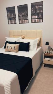 a bedroom with a large bed with black and white pillows at WA Espaco e Lazer in Barbalha