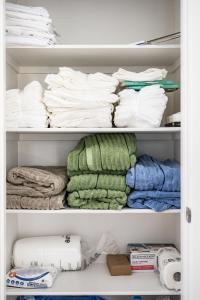 a closet filled with lots of towels at Spacious 5BR Getaway w Game Room & Modern Comfort in Fontana