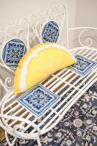 a white chair with a pillow and plates on it at Spacious 5BR Getaway w Game Room & Modern Comfort in Fontana +82 photos