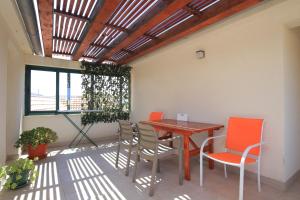a patio with a wooden table and chairs at Apartments with parking space Stupin Celine, Rogoznica - 23929 in Rogoznica +10 photos