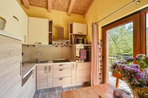 eine Küche mit weißen Schränken und einem großen Fenster in der Unterkunft Family friendly house with a swimming pool Maovice, Zagora - 24726 in Vrlika