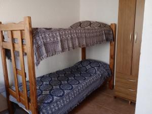 a bedroom with two bunk beds in a room at Elmosquetal in Villa Yacanto