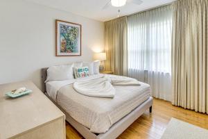 a bedroom with a bed with a large window at Less Than half Mi to Coast New Smyrna Beach Getaway in New Smyrna Beach +18 photos