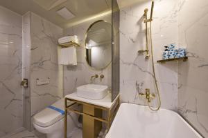 a bathroom with a sink and a tub and a toilet at Blueduck hotel in Seoul +125 photos
