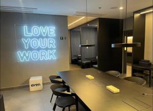 a room with a table and a sign that says love your work at Studio 1805 - A Poucos Metros do Allianz Park in Sao Paulo +40 photos