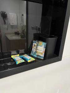 a black counter with some toothpaste and a bucket at Studio 1805 - A Poucos Metros do Allianz Park in Sao Paulo