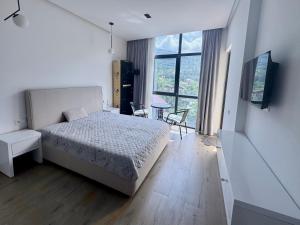 a bedroom with a bed and a table with chairs at Gonio Studio in Batumi in Kvariati
