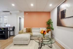 a living room with a couch and a glass table at Chic DT MTL Condo with Rooftop, BBQ in Montréal