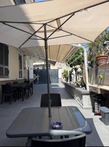 a table with an umbrella on a patio at Life Vesuvio in Torre del Greco +1 photo