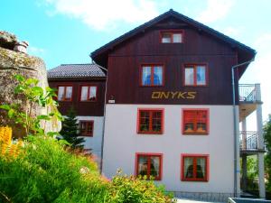 a large white building with a black roof at Willa Onyks in Szklarska Poręba