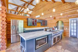 a large kitchen with wooden walls and a wooden ceiling at Red Hawk Ridge SD Mag Design Winner in Alpine