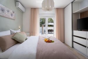 a large white bed with a plate of fruit on it at NEW! Villa Angela A modern Family Retreat in Krivodol +48 photos