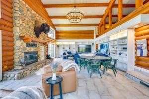 a living room with a stone fireplace and a table and chairs at Japatul House w Pool & Spa 5 Star Google Reviews in Alpine +69 photos