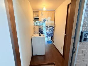 a small kitchen with a sink and a refrigerator at 西山ハウス202 in Nagasaki +5 photos