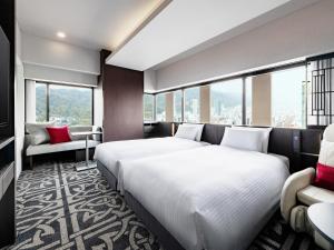 remm plus Kobe Sannomiya客房内的一张或多张床位