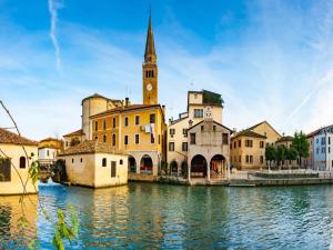 a view of a city with a river and a church at Apartment in Porto Santa Margherita by Beach in Porto Santa Margherita di Caorle