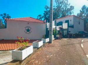 a white building with a sign on the side of it at Beautiful Room in the montains in Estrela