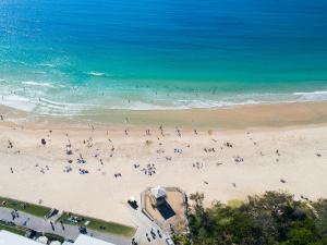 a group of people on a beach near the ocean at Landmark Resort in Mooloolaba +126 photos