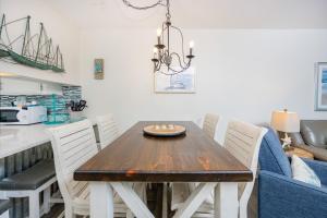 a dining room with a wooden table and chairs at Harbor House B19 condo in Gulf Shores