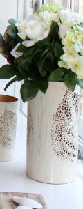 a white vase filled with white flowers on a table at Home sweet home CPH in Copenhagen