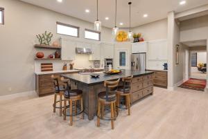 a large kitchen with a large island with bar stools at Scottsdale Luxury Heated Pool Desert Views For 6 in Scottsdale