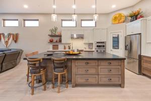 a kitchen with a large island with bar stools at Scottsdale Luxury Heated Pool Desert Views For 6 in Scottsdale +29 photos