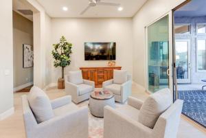 a living room with white chairs and a table at Scottsdale Luxury Heated Pool Desert Views For 6 in Scottsdale
