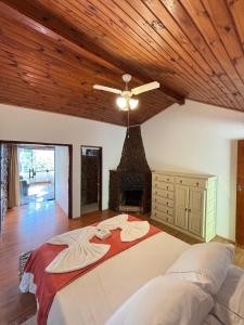 a bedroom with a large bed with a fireplace at Pousada e Spa Vrindávana in Teresópolis