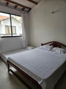 En eller flere senge i et værelse på Cómoda casa cerca a la playa + 6 billeder