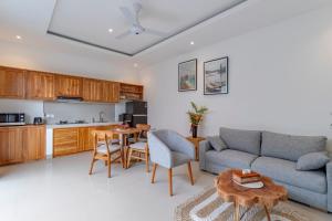 a living room with a couch and a table at Villa Uma Tegal Cemagi in Cemagi