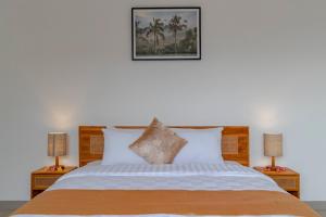 a bedroom with a large bed with two night stands at Villa Uma Tegal Cemagi in Cemagi +41 photos