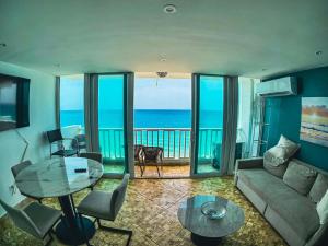 a living room with a view of the ocean at Condado Beachfront- Perfect for Families! in San Juan