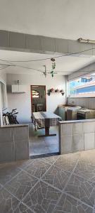 a living room with a table in the middle of a room at CasaPraiaSol1 in Rio das Ostras