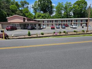 a large building with cars parked in a parking lot at The Edyn Motel in Wytheville
