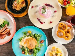 a table with plates of food on it at Hotel Cocktail Stay Naha in Naha
