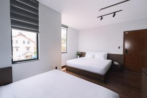 Postel nebo postele na pokoji v ubytování Scenery Hotel DaLat