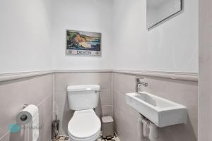 a bathroom with a toilet and a sink at 2 Bed - Apartment No. 1 Windsor Villas in Plymouth +15 photos