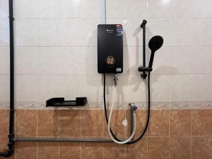 a shower head and a microphone on a wall at Vintage-Living 2Storey Haus12Pax in Simpang Ampat +33 photos