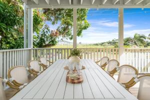 a white table and chairs on a porch at Sea Sage Cottage 4703 in Yeppoon +51 photos