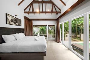 Postel nebo postele na pokoji v ubytování Zara Beach Resort Koh Samui