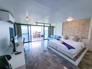 a bedroom with a large bed and a brick wall at Tawanja Resort in Ban Mai +92 photos
