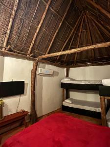 Ein Bett oder Betten in einem Zimmer der Unterkunft Tawaca Ecohotel