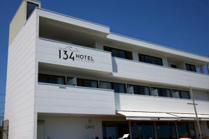 a white building with a sign that reads hotel at Hotel134 鎌倉 in Kamakura