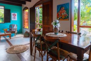una sala da pranzo con tavolo e sedie in legno di Casa Bela do Sol a Ilha de Boipeba