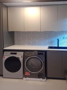 a kitchen with a washing machine and a counter at Luxury Villa with Ocean Views ! Minimum booking 1 week in Cascavelle