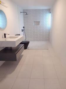 a white bathroom with a sink and a shower at Luxury Villa with Ocean Views ! Minimum booking 1 week in Cascavelle +26 photos